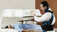 Doctor performing a fluoroscopy scan on a patient
